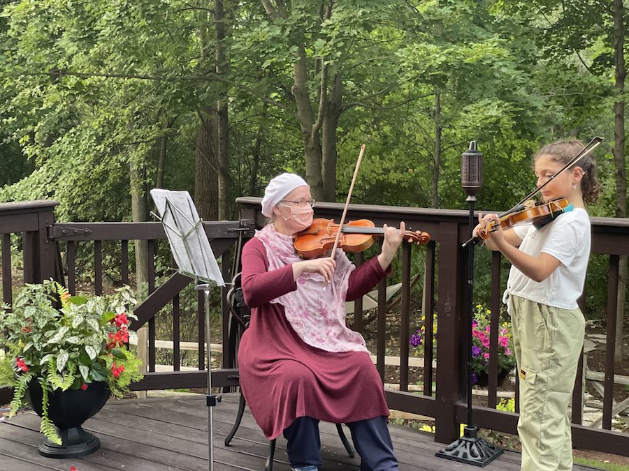 Girl and teacher playing the violin